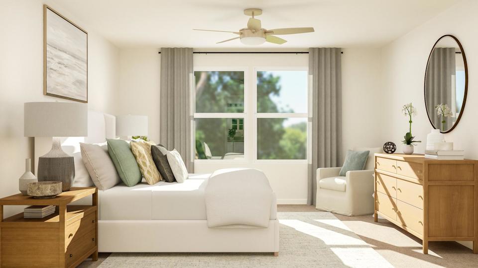 A living room with a white couch and a white table.