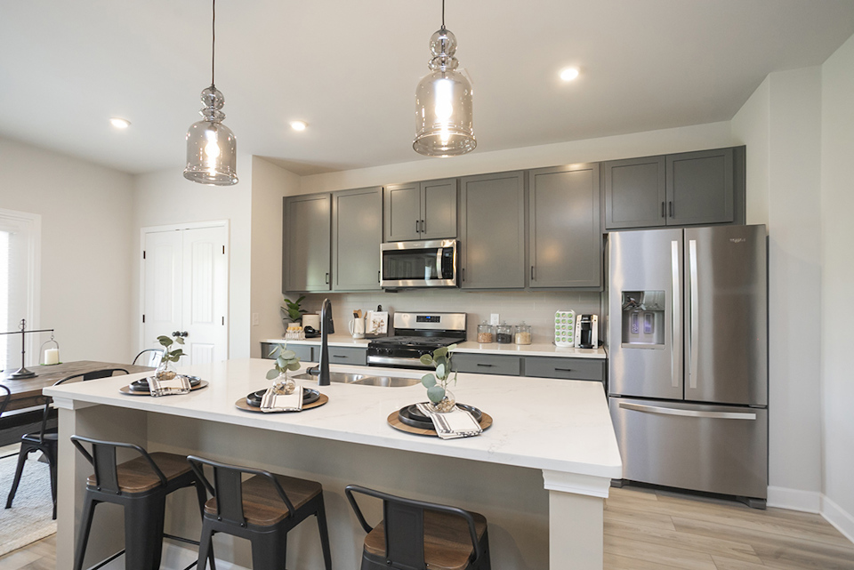A kitchen with a table and chairs.