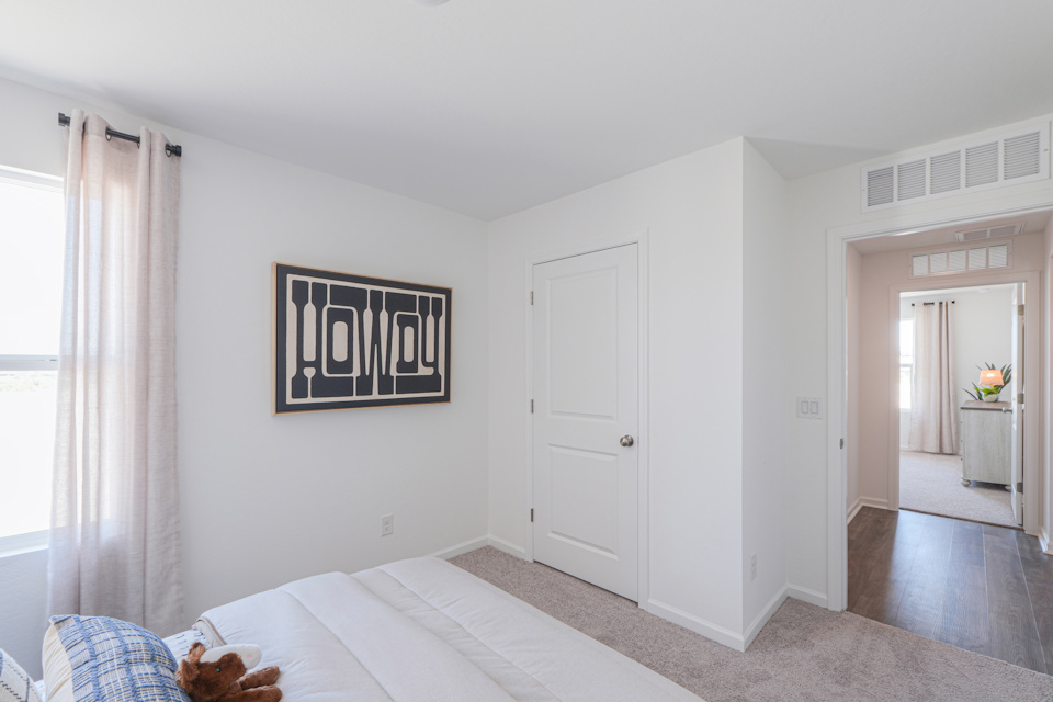 A bedroom with a bed and a window.