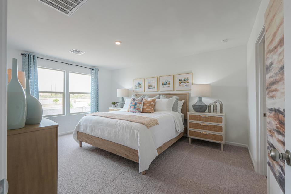 A bedroom with a bed and a window.