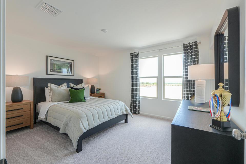 A bedroom with a bed and a tv.