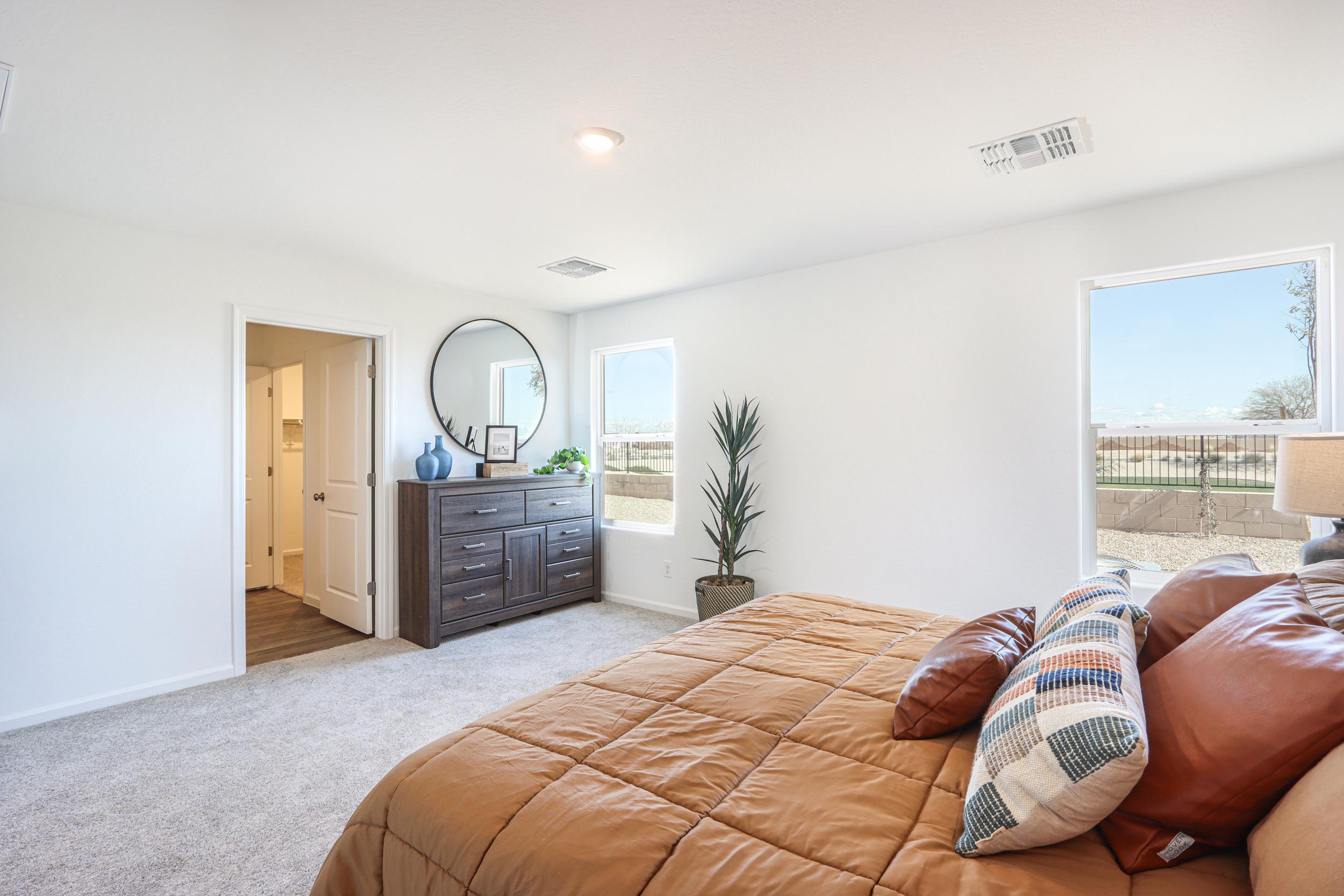 A living room with a couch and a mirror.