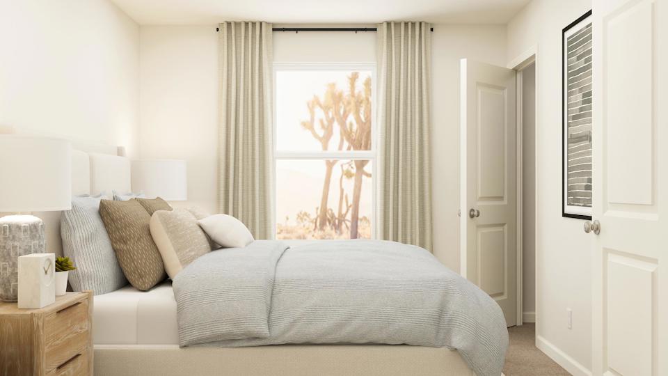 A bed with a white bed spread.