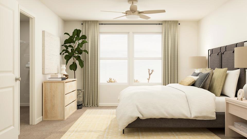 A bedroom with a bed and a fan.