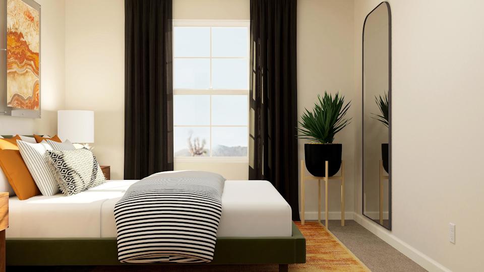 A bedroom with a large window.