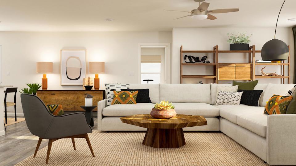 A living room with a white couch and a table.