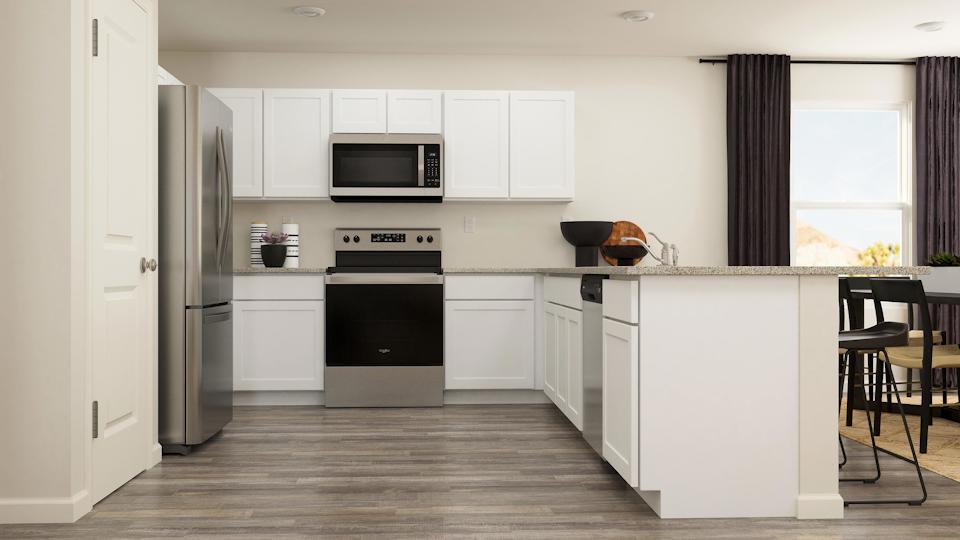 A kitchen with white cabinets.