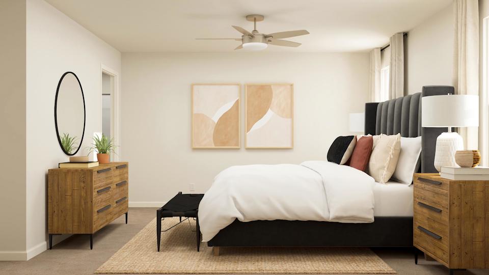 A bedroom with a bed and a fan.