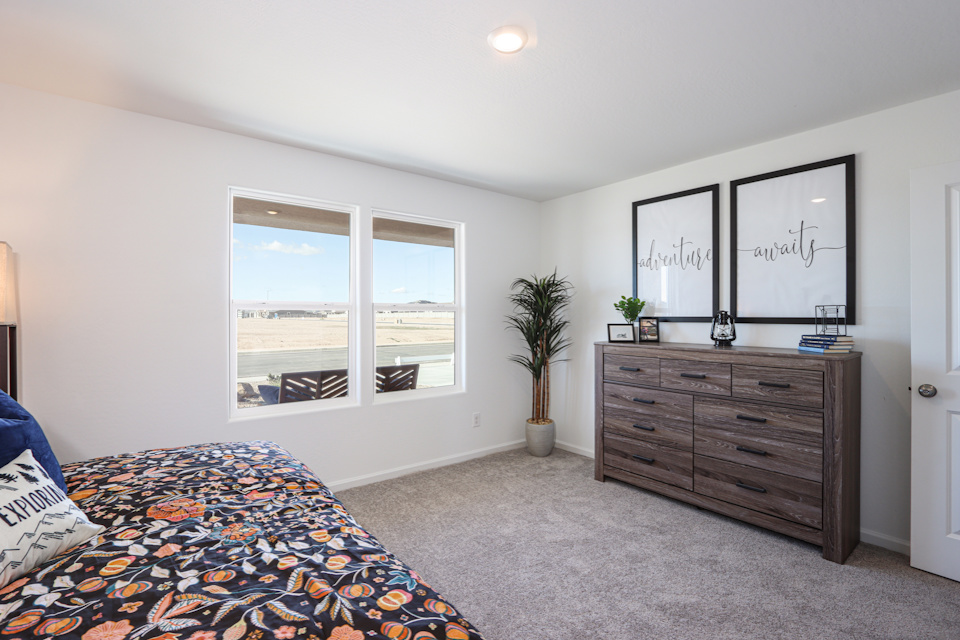 A bedroom with a bed and a dresser.
