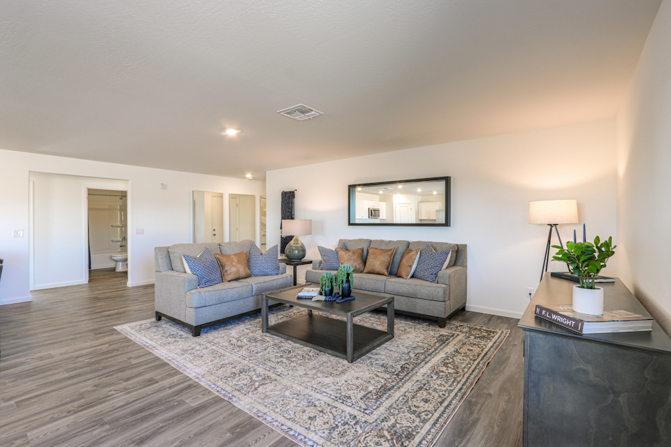 A living room with a rug and a coffee table.