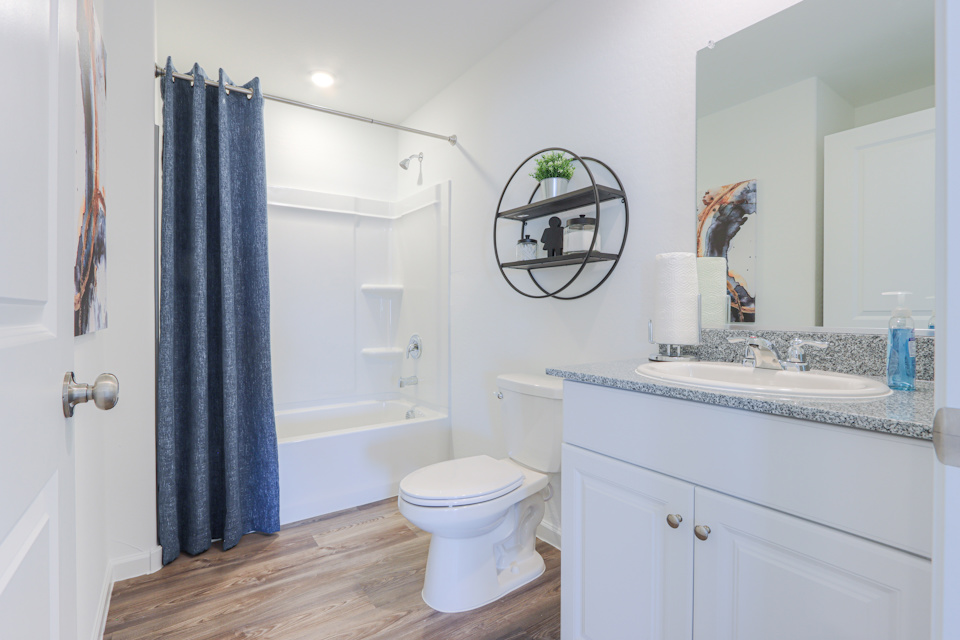 A bathroom with a tub sink and toilet.