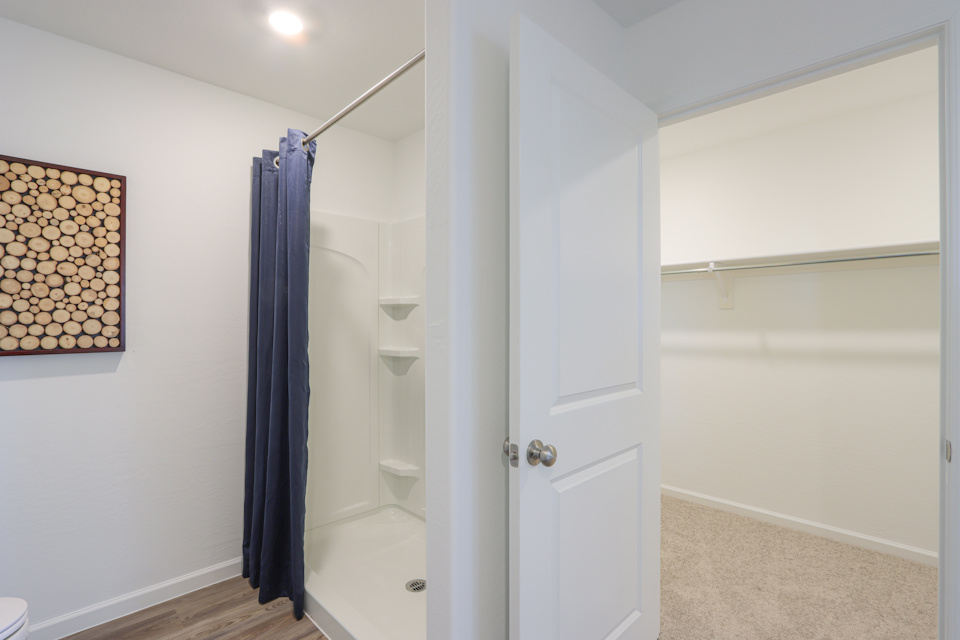 A bathroom with a shower and a bathtub.
