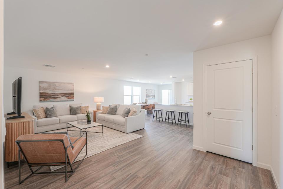 A living room with a wood floor.