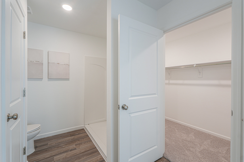 A bathroom with white doors.