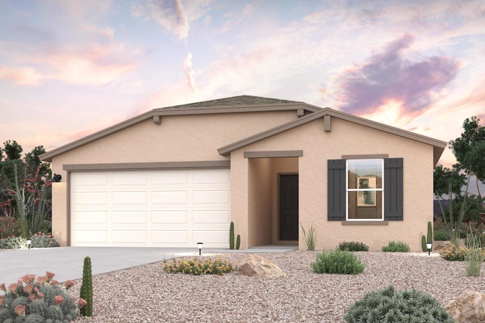 A house with a garage and bushes.