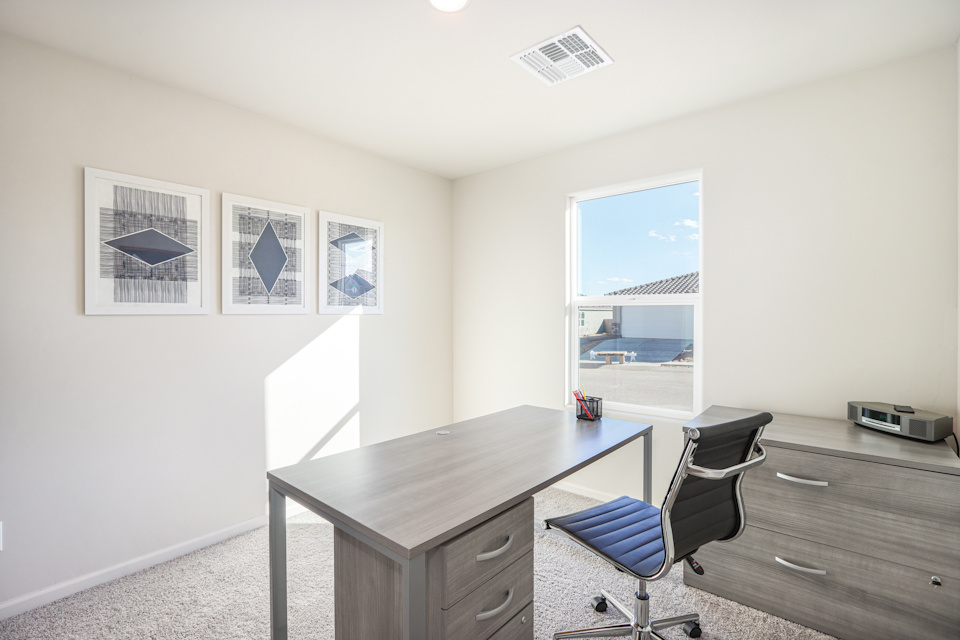 An office with a desk and chairs.