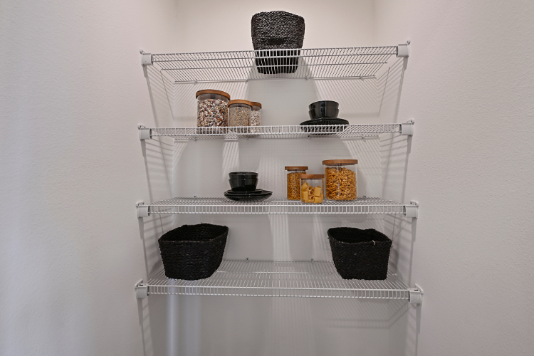 A white shelving unit with various objects on it.