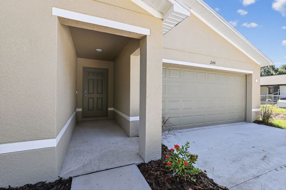 A house with a garage and a door.