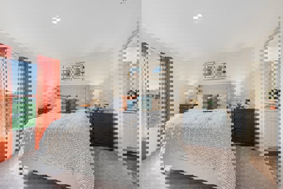 A bedroom with a large window.