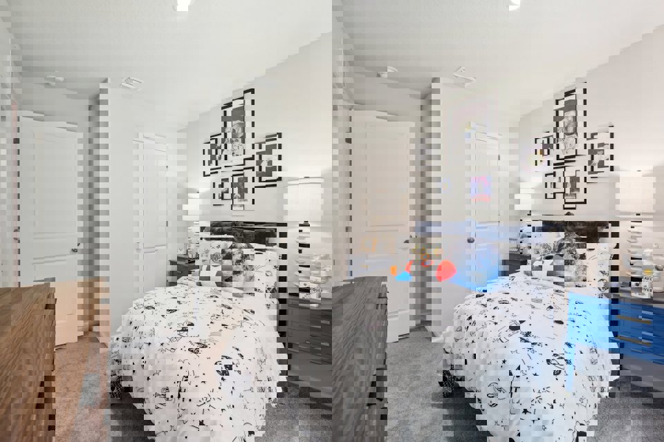 A bedroom with a bed and a dresser.