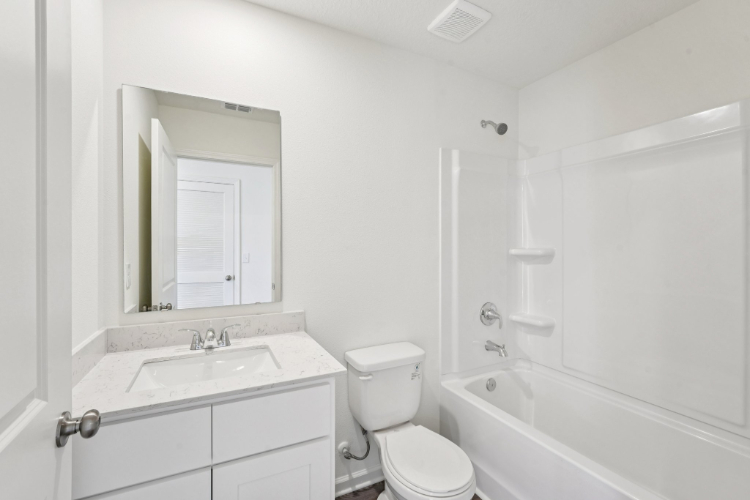 A bathroom with a toilet and sink.