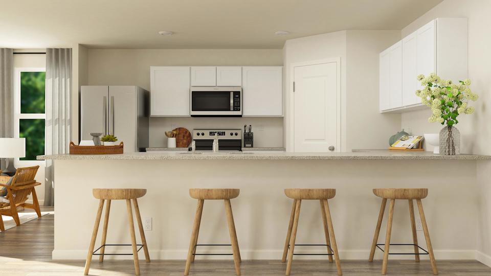 A kitchen with white cabinets.