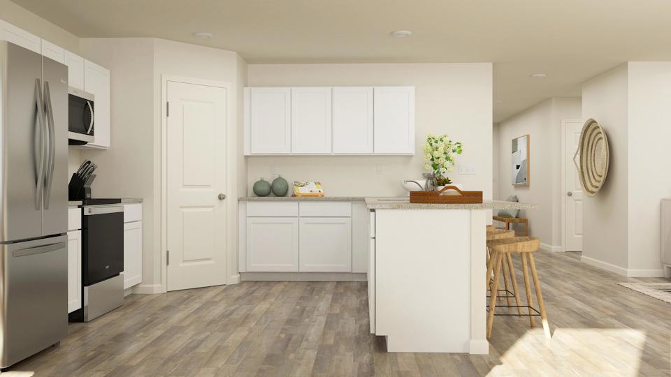 A kitchen with white cabinets.