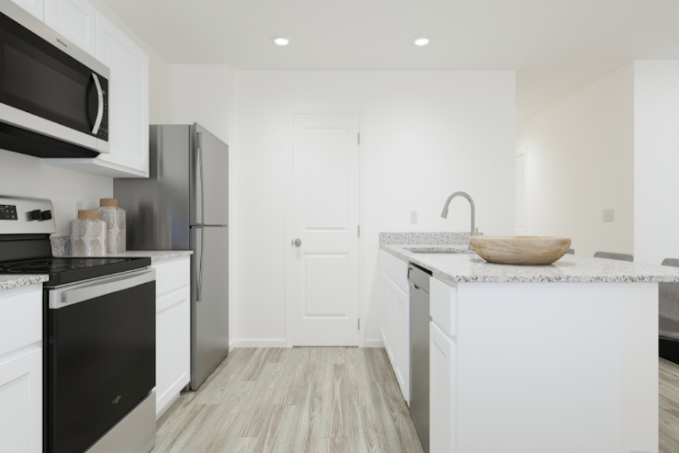 A kitchen with white cabinets.