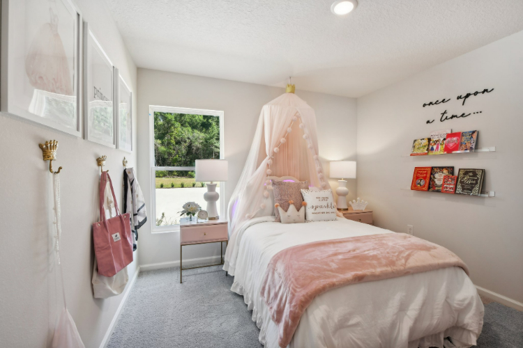 A bedroom with a pink bed.