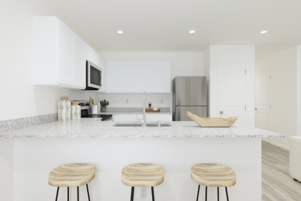 A kitchen with white cabinets.