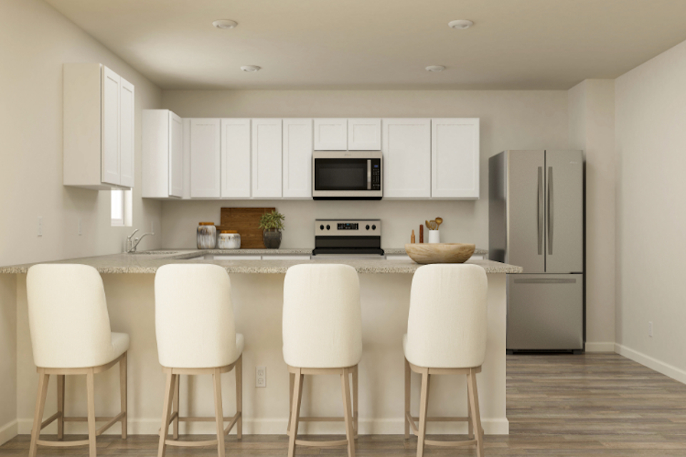 A kitchen with white cabinets.