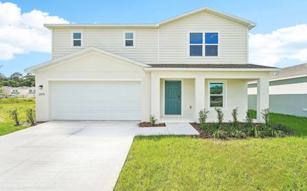 A white house with a garage.
