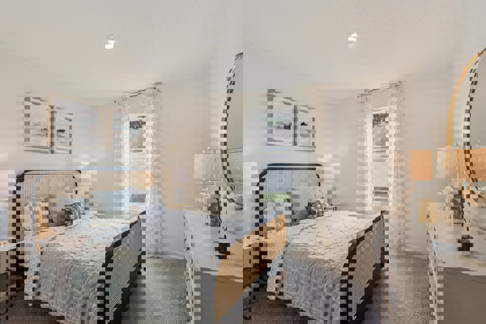 A bedroom with a bed and lamps.