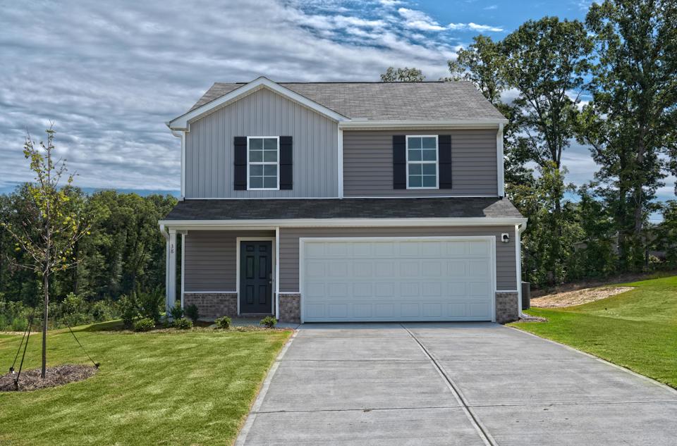 A house with a garage with Ronald Reagan Boyhood Home in the background.