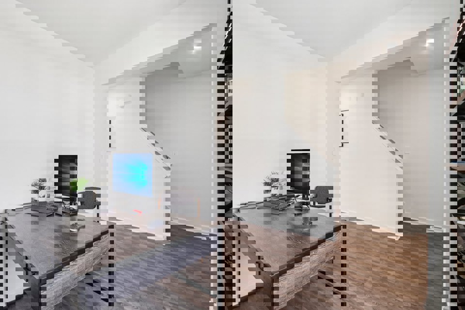 A room with a desk and a computer.