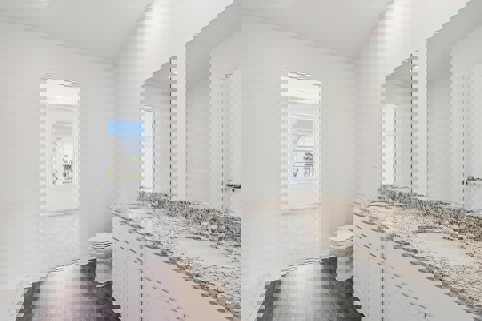 A bathroom with a marble countertop.