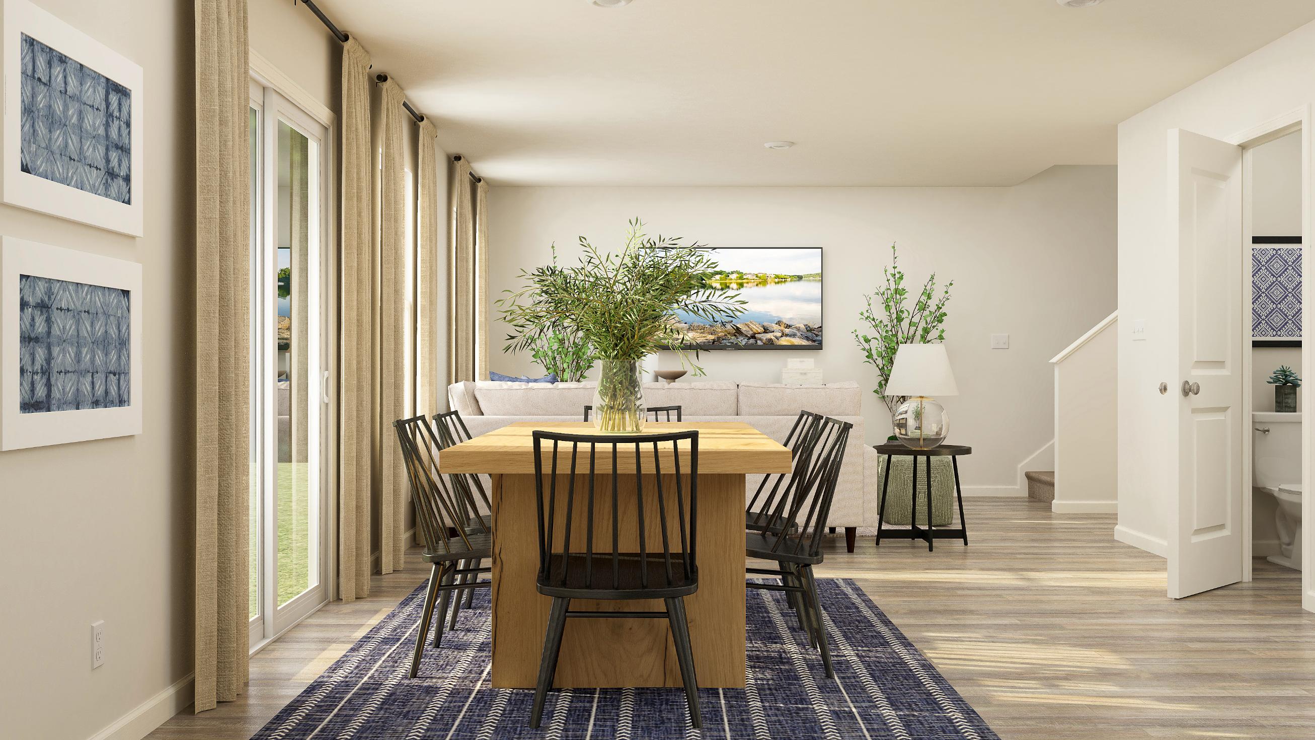 A dining room with a table and chairs.