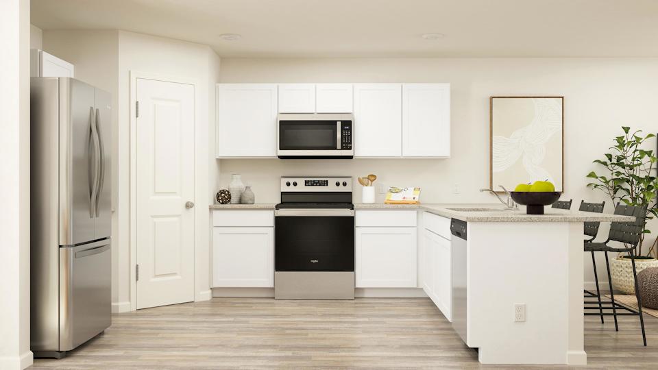 A kitchen with white cabinets.