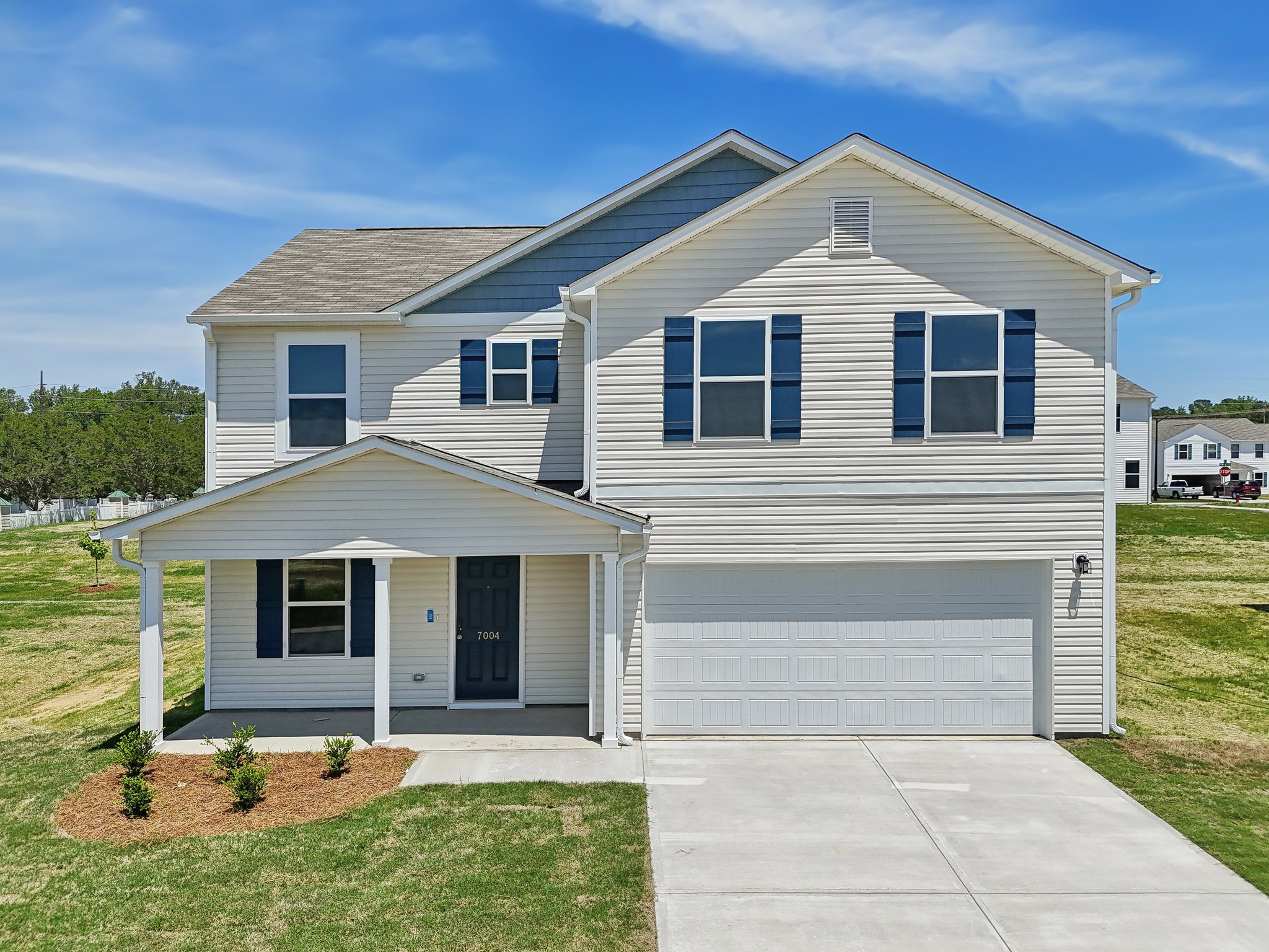 A white house with blue shutters.