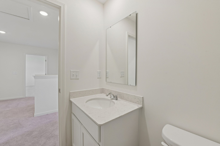 A bathroom with a sink and mirror.