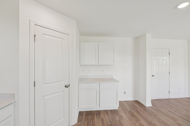 A room with white cabinets.