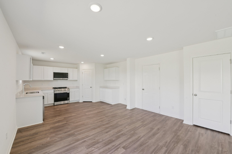 A kitchen with white cabinets.