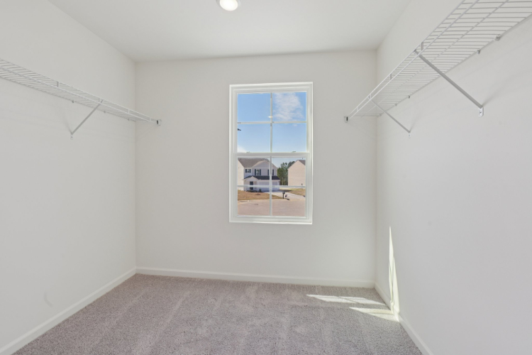 A room with a window and a carpet.