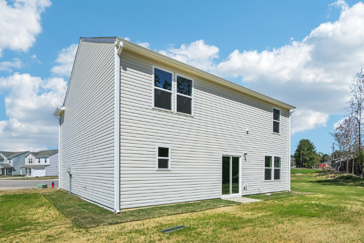 A white house with a grass yard.