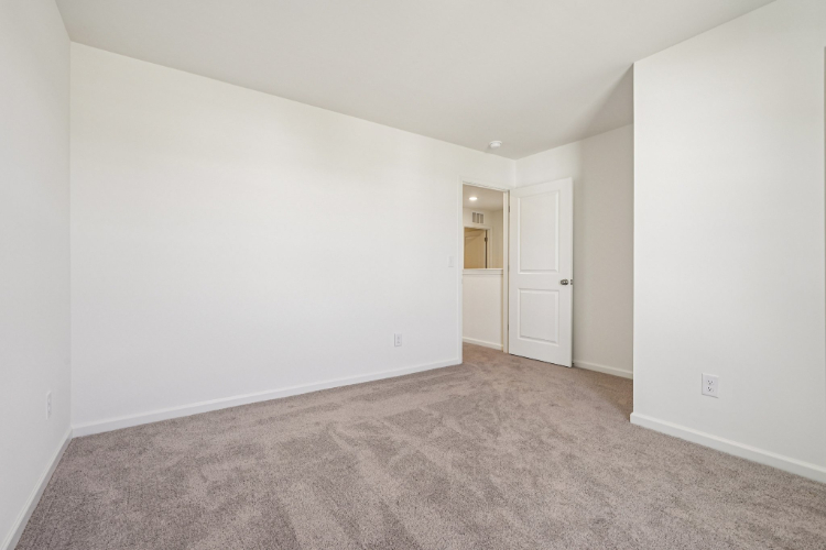 A hallway with white walls.