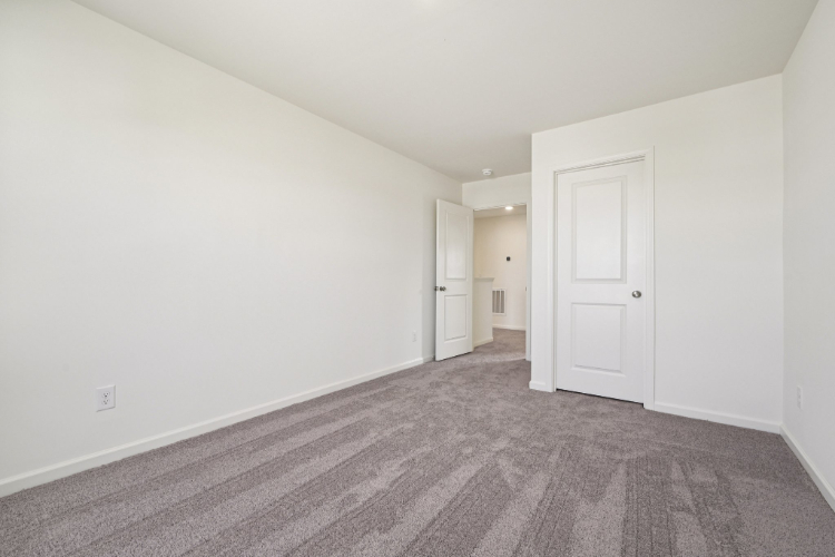 A hallway with white doors.