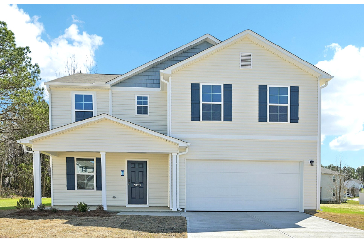A white house with a garage.