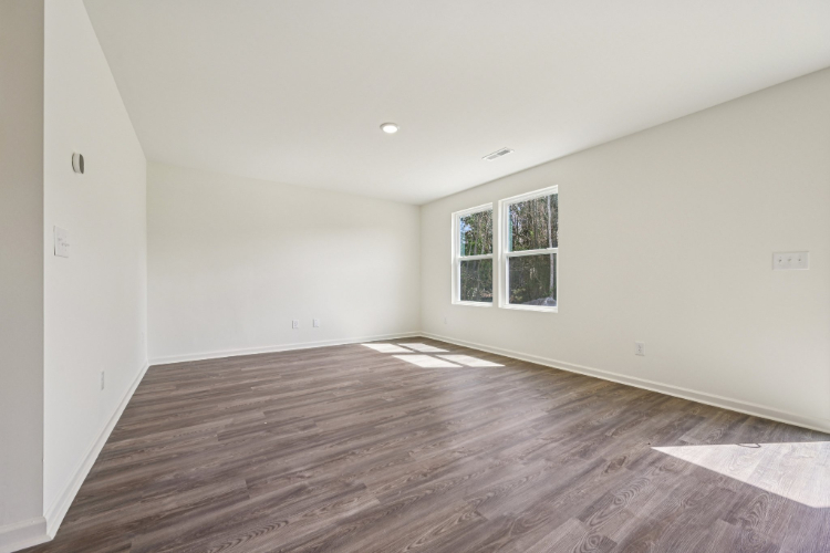 A room with a wood floor and a window.