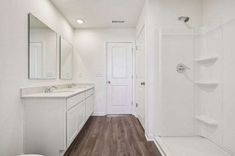 A bathroom with white walls.