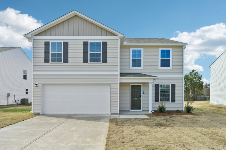 A white house with a garage.